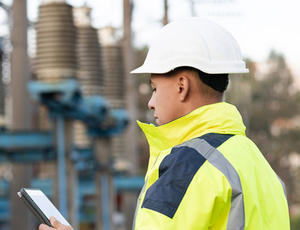 Employee analyzing utility grid station