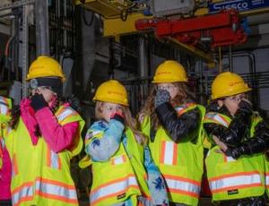 School children in Veolia protective equipment hold their noses during a tour of a wastewater treatment facility in Nassau County 