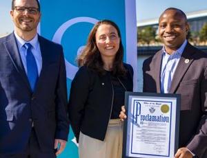 Milwaukee Mayor Johnson, Karine Rougé (CEO of Veolia North America's Municipal Water division), and Pete Coffaro (Director, Community Outreach & Business Engagement for MMSD) smile for a photo proclaiming April 22 "Veolia Ecofactory Day" 