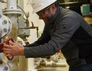 A Veolia employee works with water treatment equipment