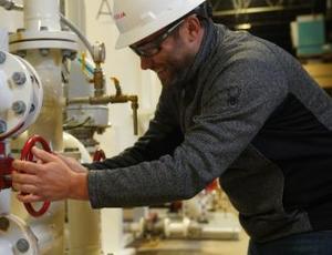 A Veolia employee works with water treatment equipment