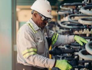 A Veolia employee works with water treatment equipment