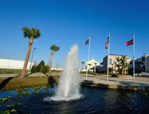 The Tampa Bay facility is seen with a water fountain in the foreground