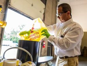 A Veolia employee works in a facility managing low-level radioactive material