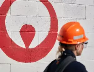 Woman walking by Veolia logo