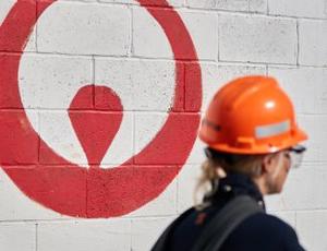 Woman walking by Veolia logo