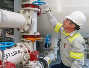 A Veolia employee working with water treatment equipment