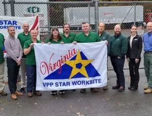 Veolia's hazardous waste team in Virginia team holds a banner that says "VPP Star Worksite"