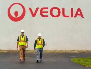 Two Veolia employees walking through a site. 