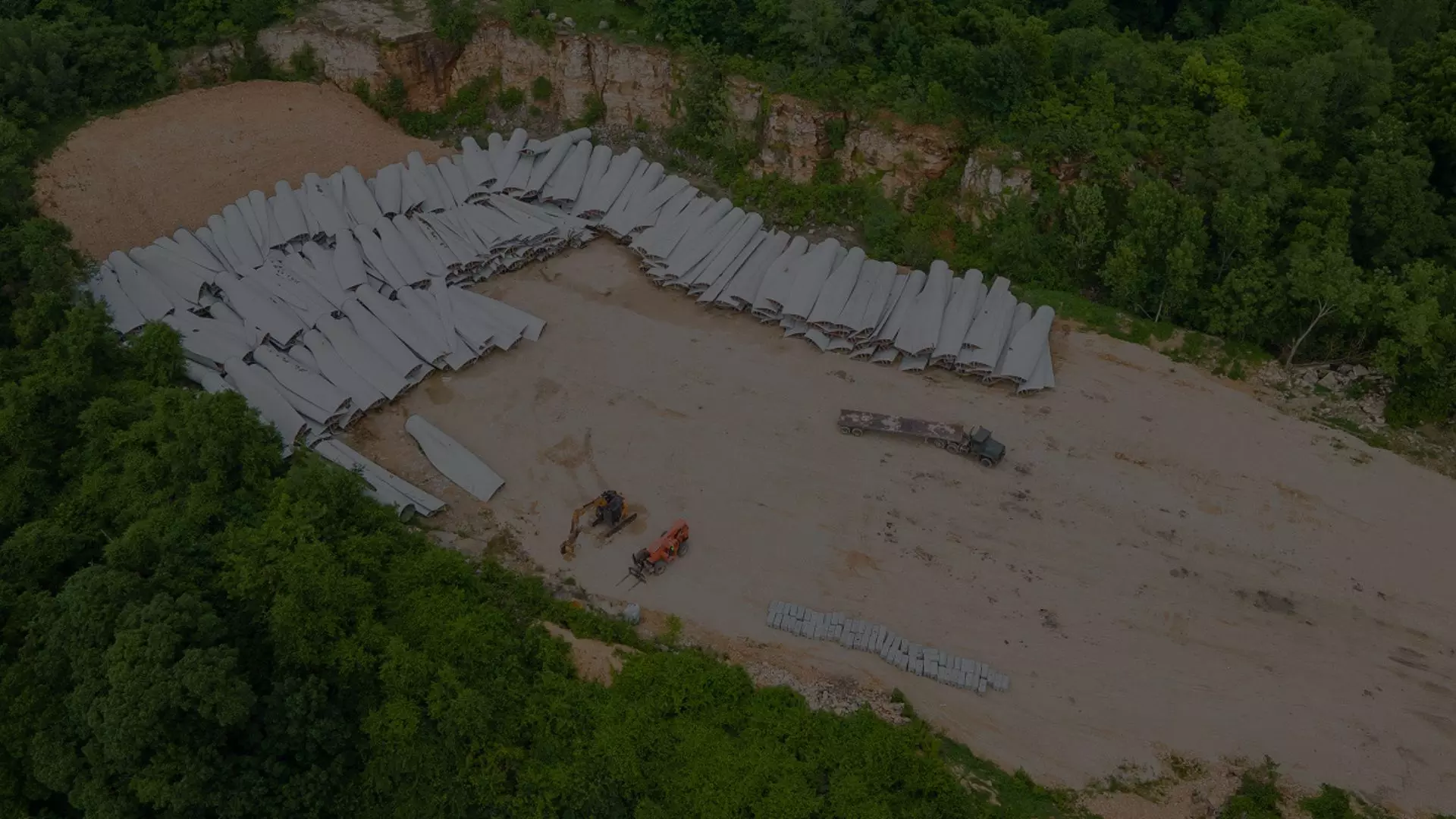 An aerial view of a pile of wind turbine blades ready for further processing