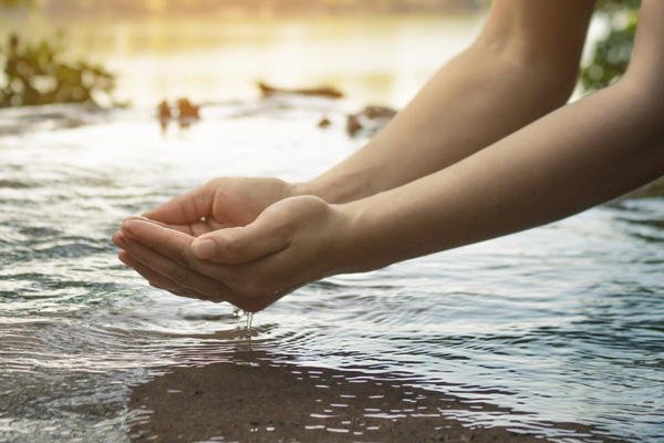 Hands in Water on Sunny Day