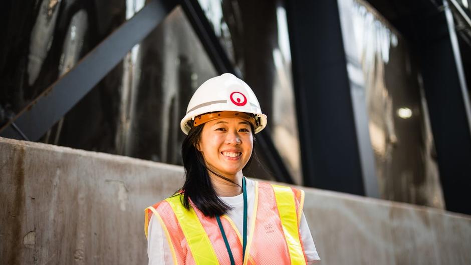 A female Veolia Ecofactory employee smiles at the camera