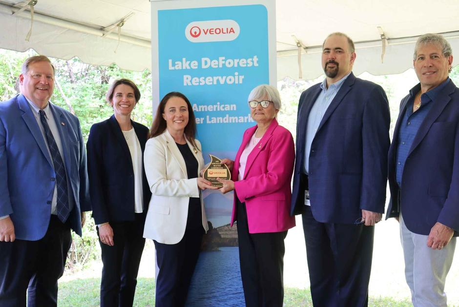 Leaders from Veolia North America and the American Water Works Association present the Lake DeForest National Landmark designation
