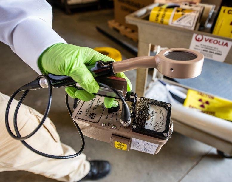 A Veolia employee works in a facility managing low-level radioactive material
