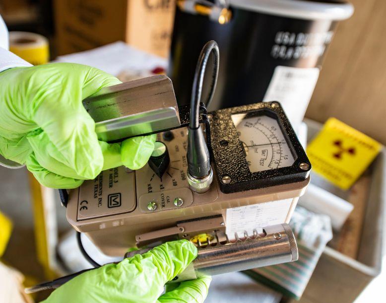 A Veolia employee measures radioactivity