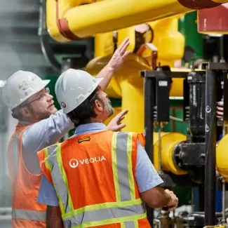 Veolia team members work with energy infrastructure 