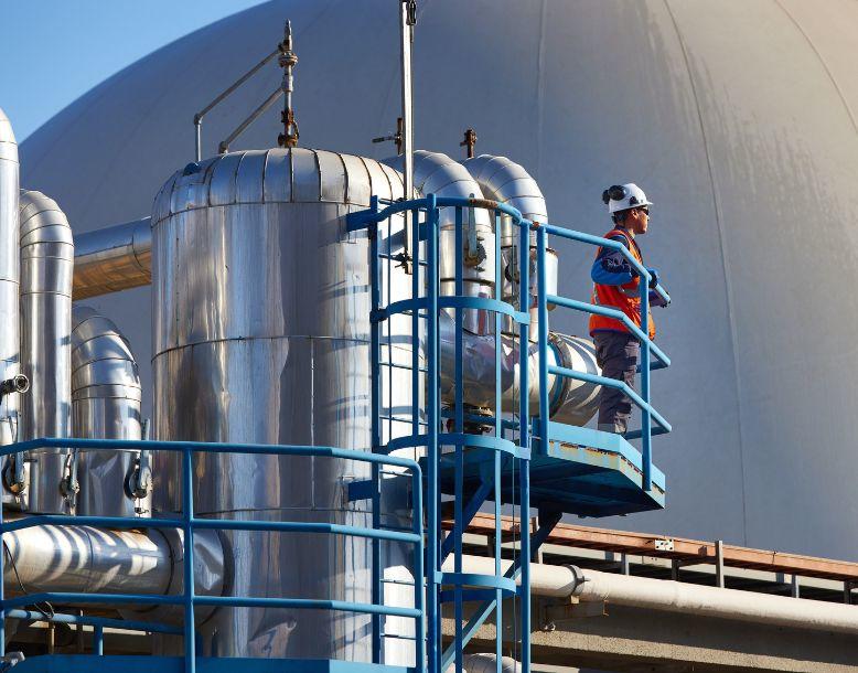 A Veolia employee stands looks over an anaerobic digestion facility