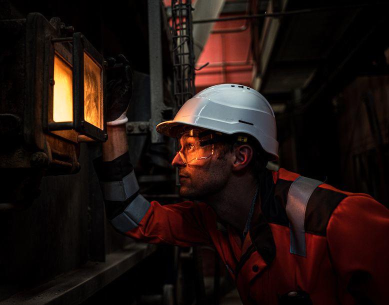 A Veolia employee looks into an industrial process