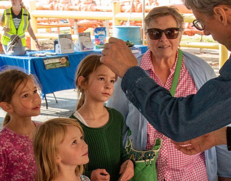 A Veolia employee talks to children at a community event
