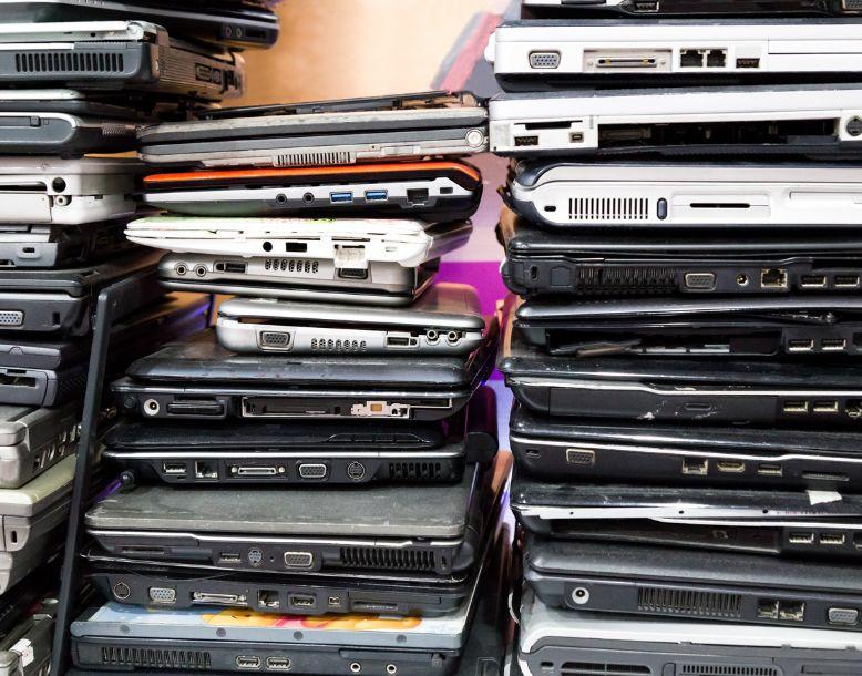 A stack of outdated and obsolete laptops