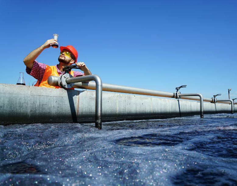 A water utility worker testing water quality for reuse