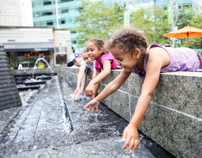 Children play in a public water fountain