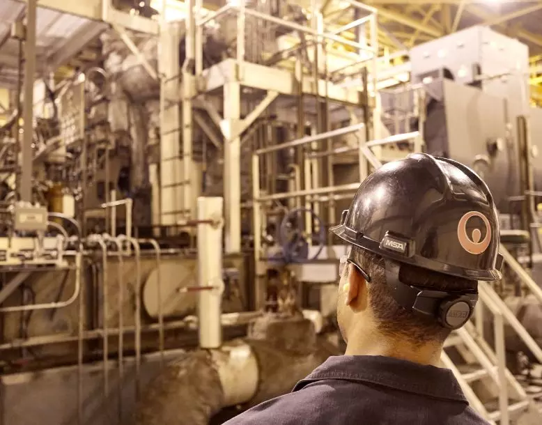 A Veolia employee looks at an onsite power generation system