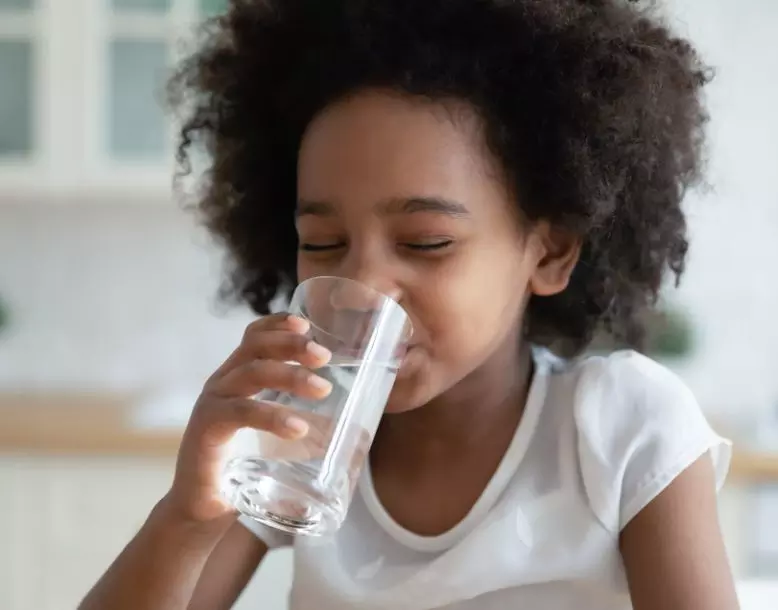 A child drinks a glass of water