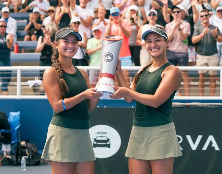 Two pickleball champions smile for a photo holding the Veolia trophy