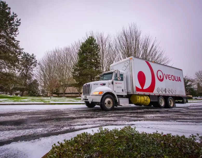 A Veolia truck drives down the road