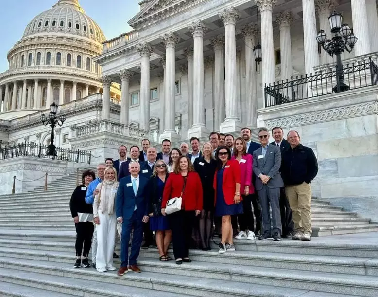 A group photo standing on the steps of the capitol building